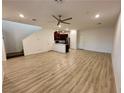 Open-concept living space features hardwood floors, a modern ceiling fan, and staircase access at 3245 Montage Dr, Henderson, NV 89044