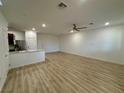 Bright living area boasts an open layout, hardwood floors, modern ceiling fan, and recessed lighting at 3245 Montage Dr, Henderson, NV 89044