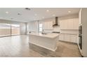 Modern kitchen with white cabinets, stainless steel appliances, and a spacious center island at 853 Bittern Lake St, Henderson, NV 89011