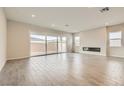 Bright living room featuring gray floors, large windows, and a sleek fireplace at 853 Bittern Lake St, Henderson, NV 89011