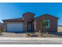 Modern stucco home with a white garage door and stone accents at 1005 Warsaw Ave, Henderson, NV 89015