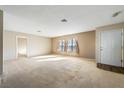 Bright living room with neutral carpeting and large windows at 2360 Greyhound St, Pahrump, NV 89060