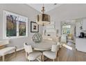 Elegant dining area with round table, modern lighting, and hardwood floors at 5012 Shoal Creek Cir, Las Vegas, NV 89113