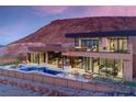 Luxury home showcasing a pool, patio, and hilltop views at 7 Stoneshead Ct, Henderson, NV 89012