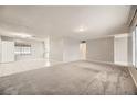 Open living area with grey carpet and tiled floors at 3187 Silver Saddle St, Las Vegas, NV 89169