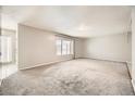 Bright living room featuring large windows and grey carpet at 3187 Silver Saddle St, Las Vegas, NV 89169
