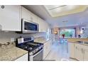 Modern kitchen with stainless steel appliances and granite countertops at 3368 Epson St, Las Vegas, NV 89129
