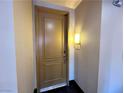 Entryway featuring a secure front door with unit number 207 and soft lighting at 71 E Agate Ave # 207, Las Vegas, NV 89123