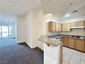 The kitchen has wooden cabinets, granite countertops, and stainless steel appliances at 71 E Agate Ave # 207, Las Vegas, NV 89123