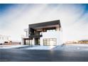 Modern two-story home with a dark accent block, a two-car garage, and desert landscaping at 3690 S Spring Mountain Blvd, Pahrump, NV 89048