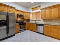 Well-equipped kitchen boasts stainless steel appliances and abundant wooden cabinetry at 10613 Grand Cypress Ave, Las Vegas, NV 89134