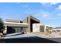 Contemporary home featuring a clean architectural design, sleek lines, and a three-car garage at 612 Dragon Mountain Ct, Henderson, NV 89012