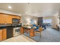 Kitchen with stainless appliances that opens to a living room with a balcony and city views at 211 E Flamingo Rd # 610, Las Vegas, NV 89169