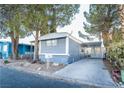 Gray mobile home with carport and paved driveway at 5119 Ridge Ave, Las Vegas, NV 89103