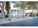 Gray mobile home with small front yard and walkway at 5119 Ridge Ave, Las Vegas, NV 89103