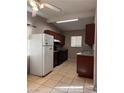 Efficient kitchen featuring wood cabinets and tile flooring at 1504 E Mcwilliams Ave, Las Vegas, NV 89101