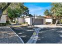 Well-maintained condo with a two-car garage, additional parking, and mature landscaping at 3427 Manzano Cir, Las Vegas, NV 89121