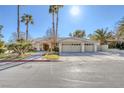 House exterior showcasing a three-car garage and palm trees at 3767 Darren Thornton Way, Las Vegas, NV 89120