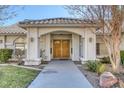 Double wood doors and walkway leading to house entrance at 3767 Darren Thornton Way, Las Vegas, NV 89120