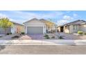 Single-story house with attached garage and brick driveway at 2043 Arrington Ave, North Las Vegas, NV 89086