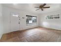 Bright living room with tiled floors, large windows providing ample natural light, and a classic ceiling fan at 1925 Franklin Ave, Las Vegas, NV 89104