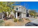 Two-story house with gray siding, gray garage door, and landscaped front yard at 3164 Rowan Brook Ave, Henderson, NV 89052