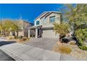 Two-story house with gray siding, gray garage door, and landscaped front yard at 3164 Rowan Brook Ave, Henderson, NV 89052