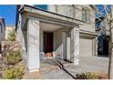 Covered porch with gray columns, brown door and gray pavers at 3164 Rowan Brook Ave, Henderson, NV 89052