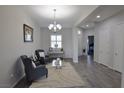 Bright living room with hardwood floors, chandelier, and a view to other rooms at 7047 Noble Flair Ct, Las Vegas, NV 89131