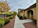 Sidewalk view of home with autumn trees and landscaping at 11416 Belmont Lake Dr # 102, Las Vegas, NV 89135