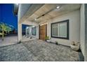 Covered entryway with modern lighting and a wood front door at 1691 Blackhorn St, Pahrump, NV 89048