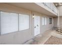 Apartment exterior with white security door, white framed windows, and stairs to upper floors at 204 Orland St # 2, Las Vegas, NV 89107