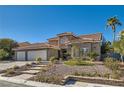 House with three-car garage, tile roof, and nicely landscaped front yard at 5205 Sandy Cactus Ln, Las Vegas, NV 89149