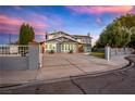 Charming two-story home with white trim, gray paint, manicured landscaping and a spacious driveway at 3531 W Arby Ave, Las Vegas, NV 89118