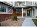 Inviting front porch area featuring a well-maintained pebble garden, brick accents, and an elegant front door at 3531 W Arby Ave, Las Vegas, NV 89118