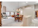 Dining room with a chandelier, round table, and view of the living room at 6143 Basilone Ave, Las Vegas, NV 89122