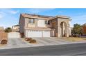 View of a two-story home showcasing a three-car garage and a spacious driveway at 6192 Rocky Top Ave, Las Vegas, NV 89110