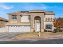 Stately two-story home featuring a grand arched entrance and three-car garage at 6192 Rocky Top Ave, Las Vegas, NV 89110