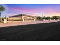 Single story home with desert landscaping and black metal fence at 647 Foxhall Rd, Henderson, NV 89002