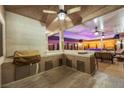 Outdoor kitchen area featuring a built-in grill, ample counter space, and bar seating overlooking the pool at 647 Foxhall Rd, Henderson, NV 89002