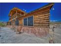 Log home exterior showcasing a side view with rocking chairs at 561 Miranda Rd, Pahrump, NV 89060