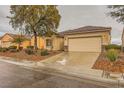 Attractive one-story home featuring a two-car garage and low-maintenance desert landscaping in the front yard at 7804 Island Rail Dr, North Las Vegas, NV 89084