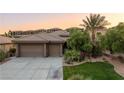 Single story home with two-car garage and manicured lawn at 1004 Crest View Dr, Mesquite, NV 89027