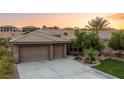 Single story home with two-car garage and manicured lawn at 1004 Crest View Dr, Mesquite, NV 89027