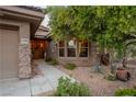 Welcoming front entry with stone accents and landscaping at 1004 Crest View Dr, Mesquite, NV 89027