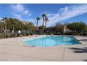 Community pool surrounded by mature trees and landscaping, offering a refreshing retreat at 4490 Rabnor Cir, Las Vegas, NV 89115