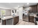 Modern kitchen features stainless steel appliances, granite countertops, and a kitchen island with a sink at 4490 Rabnor Cir, Las Vegas, NV 89115