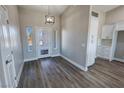 Bright and spacious entryway with modern light fixture and hardwood floors at 2750 Zephyr Ave, Pahrump, NV 89048