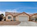 Inviting single-story home featuring desert landscaping, a two-car garage, and a well-maintained exterior at 5217 Yellow Dawn Ct, Las Vegas, NV 89130