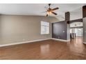 Spacious living room featuring wood floors, a ceiling fan, neutral paint, and lots of natural light at 5217 Yellow Dawn Ct, Las Vegas, NV 89130